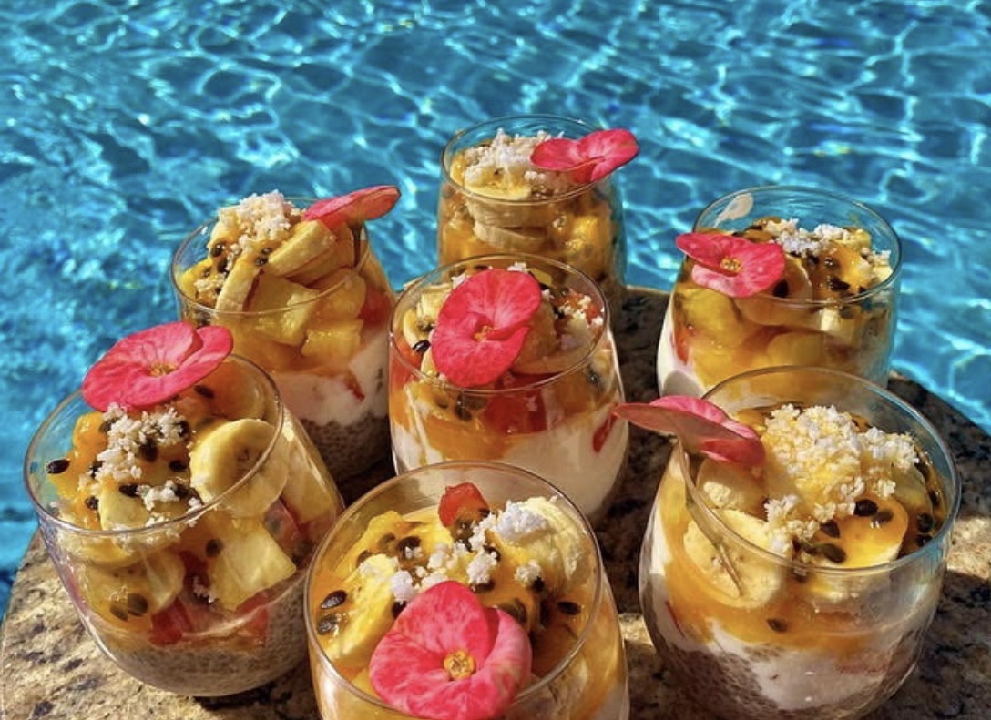 Prepared fruit cups beside the blue water of the Sanctuary pool