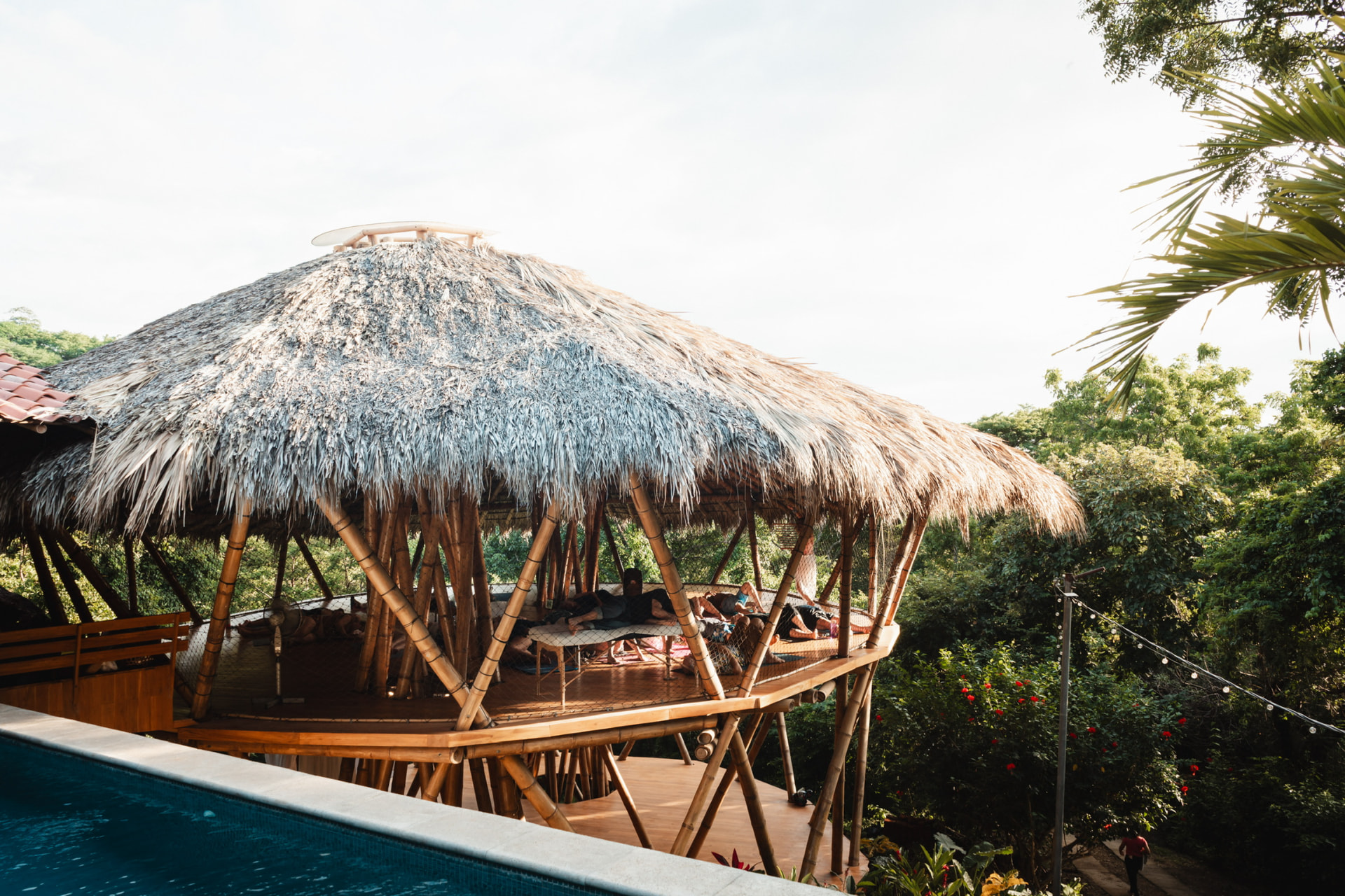 The bamboo structure at Sanctuary on the Beach seen from the side among tropical planting