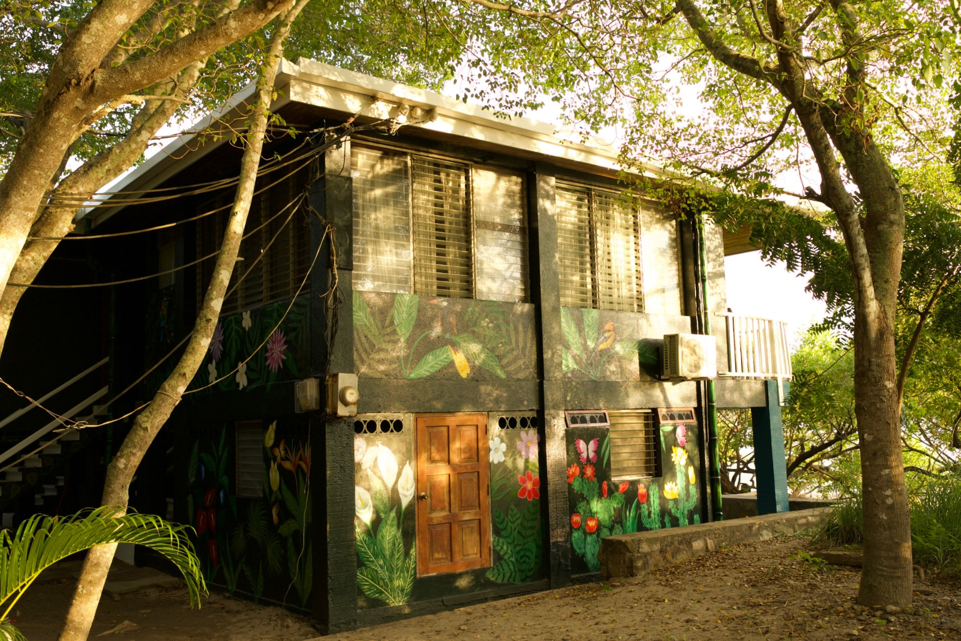 A painted outdoor wall and shaded seating area within the Sanctuary grounds